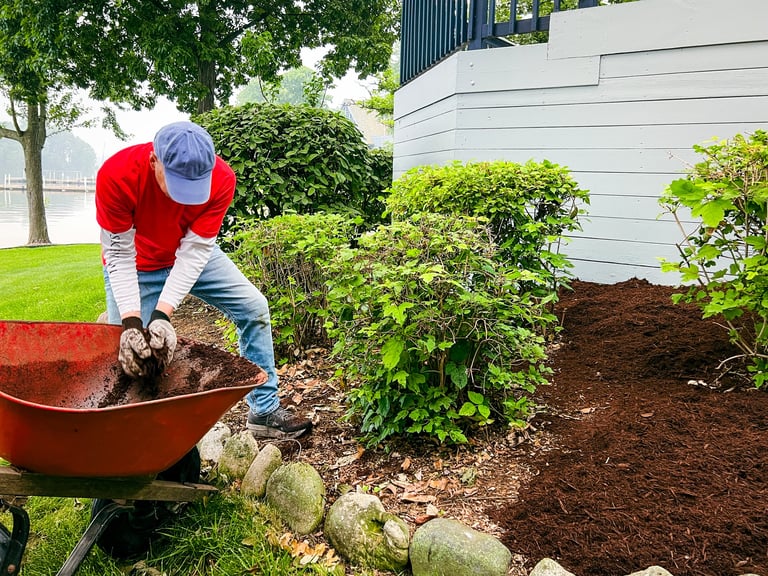 Professional landscaper unloading mulch
